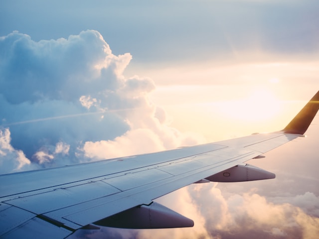 View from airplane window above clouds